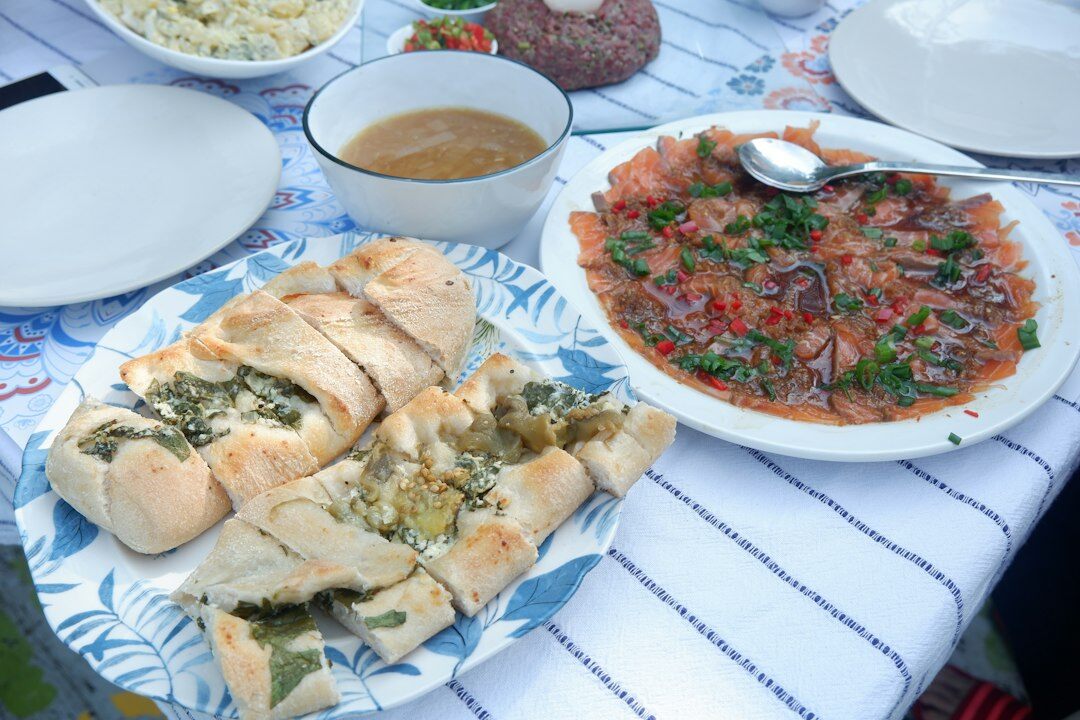 Traditional Czech dinner table with svíčková, dumplings and fresh bread